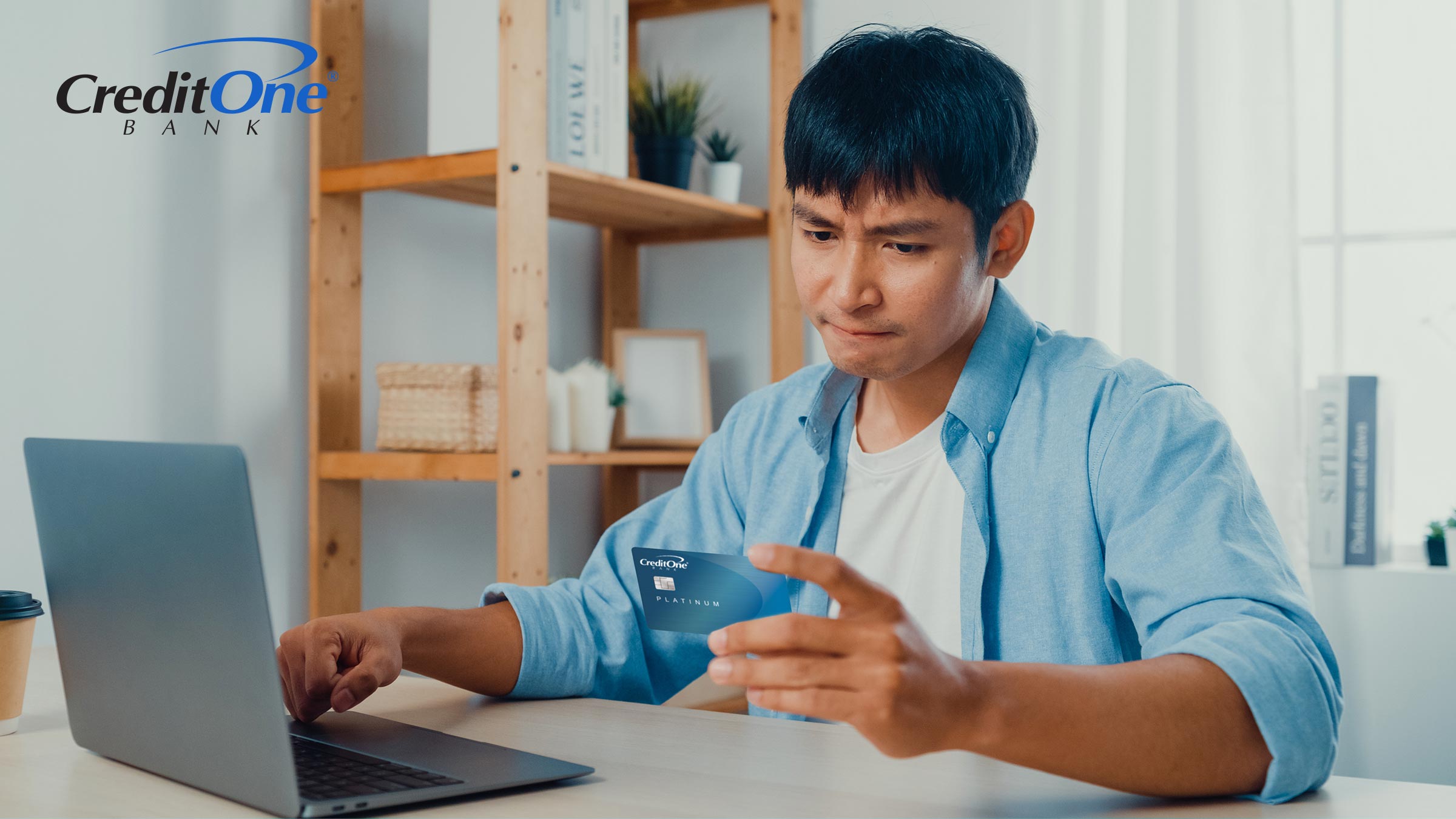 A man checks his credit card account on his laptop. He may compare similar terms like “credit limit” and “available credit” and ask “What does available credit mean?”