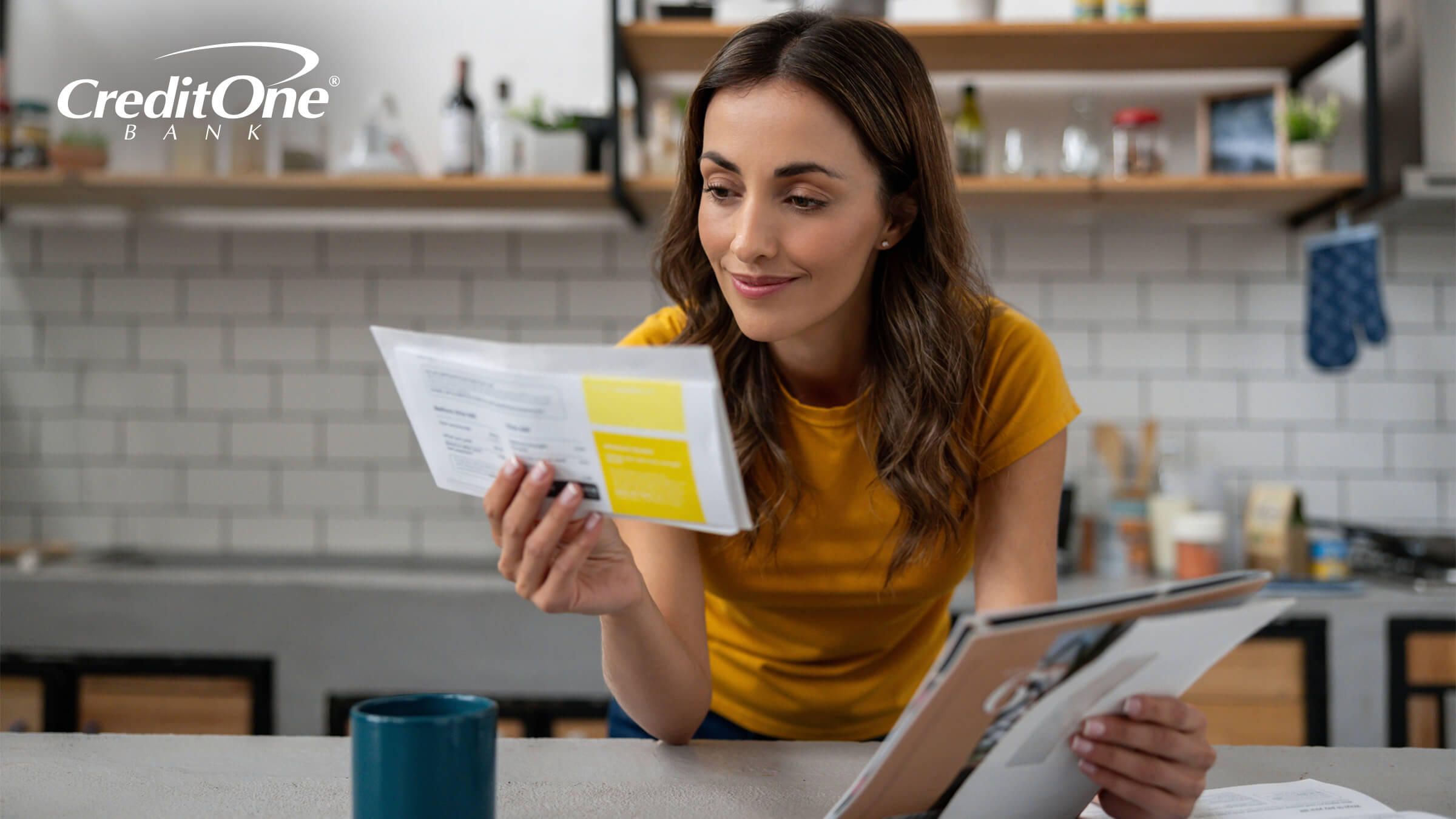 A woman smiles as she reads a piece of mail in one hand, while holding envelopes in her other hand. She may be reading the details of a pre-approved credit card offer.