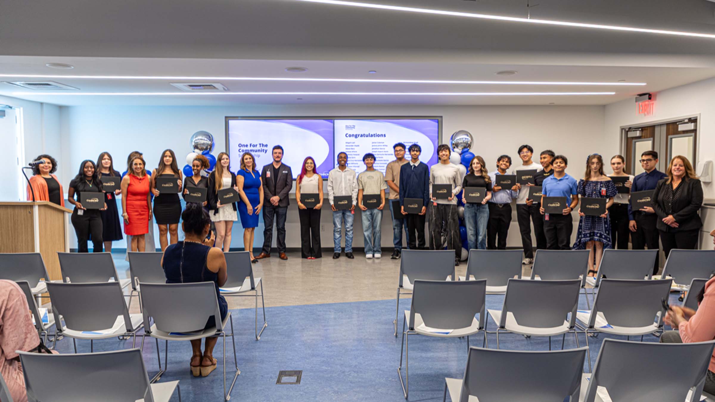 Scholarship recipients pose with their certificates at the One For The Community ceremony hosted by Credit One Bank.