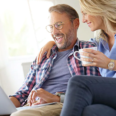A Couple Looking At a Laptop Together