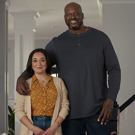 Shaq and a housewife standing together in her living room